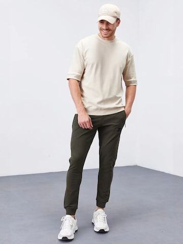 Tommy Life - Skinny Calças de desporto 'Jogginghose' em verde