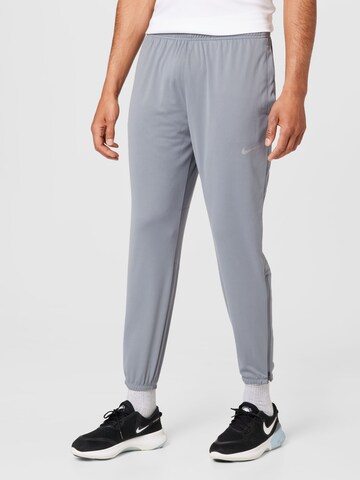 NIKE Tapered Sports trousers in Grey: front