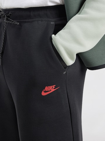 Nike Sportswear Ohlapna forma Hlače 'TECH FLC' | črna barva