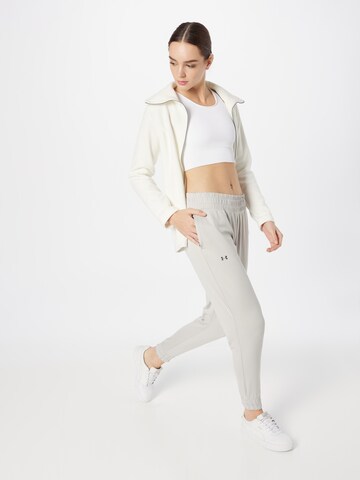 Effilé Pantalon de sport UNDER ARMOUR en gris