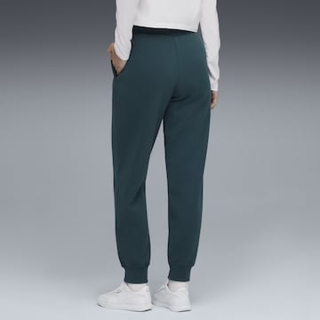 PUMA Tapered Sports trousers in Green