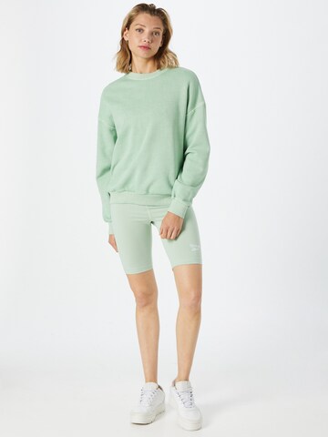 Reebok Skinny Športne hlače 'Identity' | zelena barva