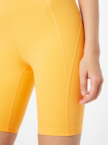 Girlfriend Collective Skinny Workout Pants in Orange