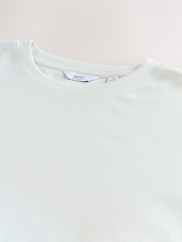 Tricou de la Next pe bej