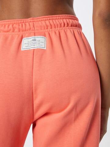 Nike Sportswear Дънки Tapered Leg Панталон в оранжево