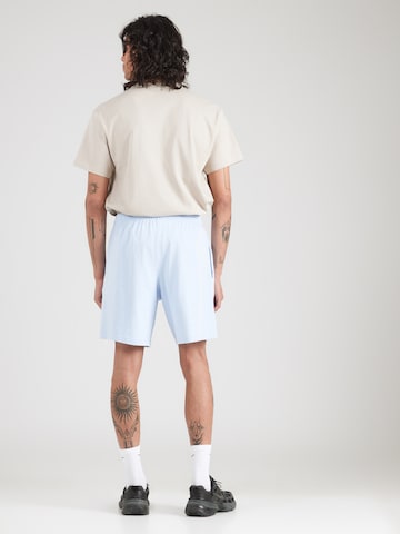 Loosefit Pantalon 'Club' Nike Sportswear en bleu