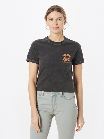 On Vacation Club - Camiseta 'Peaches and Beaches' en negro: frente
