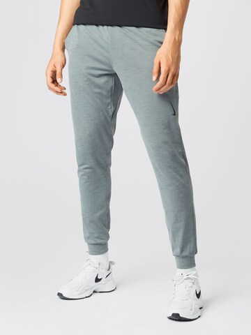 NIKE Tapered Workout Pants in Grey: front