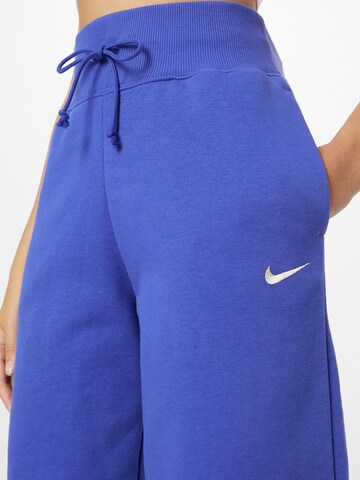 purpurinė Nike Sportswear Siaurėjantis Kelnės 'PHNX FLC'
