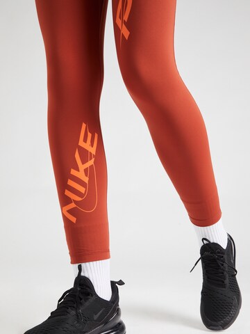 NIKE Skinny Sportbroek in Oranje