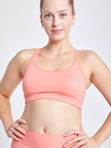 SPORTKIND Medium support Sport bh 'Crossed Straps' in Oranje