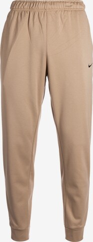 Loosefit Pantalon de sport NIKE en beige : devant