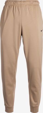 NIKE Loose fit Workout Pants in Beige: front