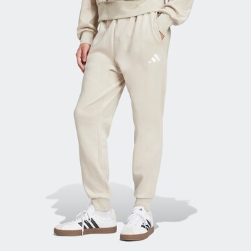 Tapered Pantaloni sportivi 'Feelcozy' di ADIDAS SPORTSWEAR in beige: frontale