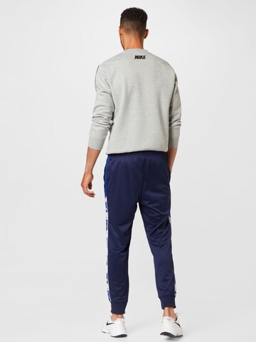 Tapered Pantaloni de la Nike Sportswear pe albastru