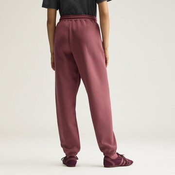 Tapered Pantaloni sportivi di ADIDAS BY STELLA MCCARTNEY in rosso
