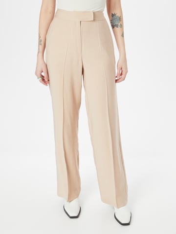 ABOUT YOU Loose fit Trousers with creases 'Marle' in Beige: front