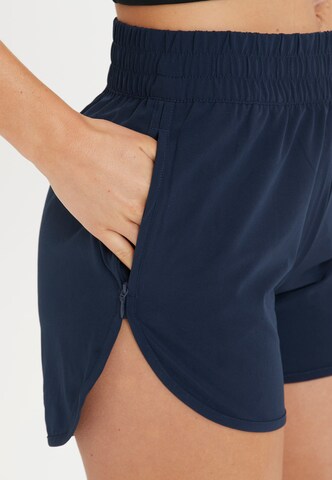 Athlecia Regular Workout Pants 'Creme' in Blue