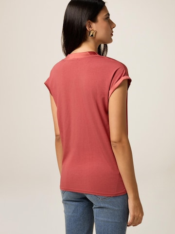 Top di oltre in rosa