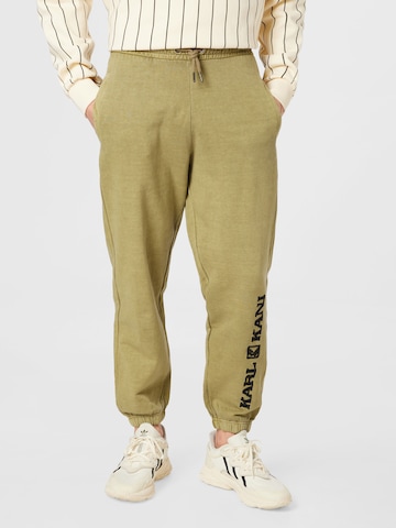 Karl Kani Tapered Trousers in Green: front