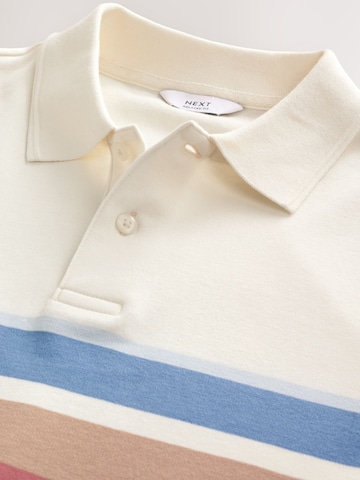 Tricou de la Next pe bej