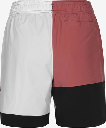 Loosefit Pantalon de sport 'Curry Woven 7' UNDER ARMOUR en rouge