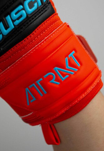 REUSCH Sports gloves 'Attrakt Freegel Silver' in Red