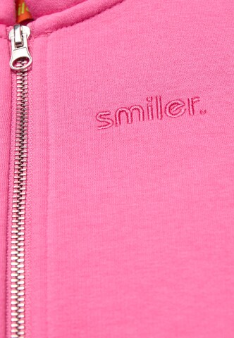 Veste de survêtement smiler. en rose