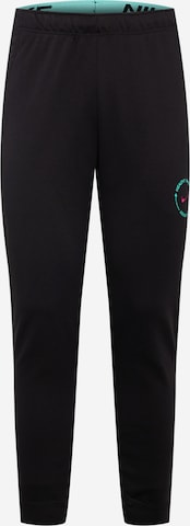 Pantalon de sport NIKE en noir : devant