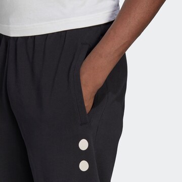 Tapered Pantaloni 'Reclaim Logo' de la ADIDAS ORIGINALS pe negru