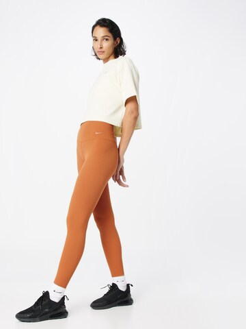 NIKE Skinny Sportbroek 'ZENVY' in Oranje