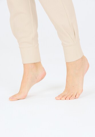 Athlecia Regular Sports trousers in Brown