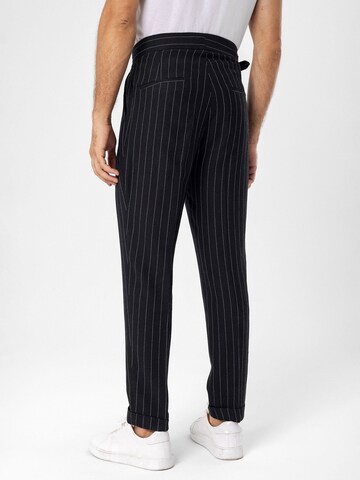 Antioch Tapered Pleat-front trousers in Black