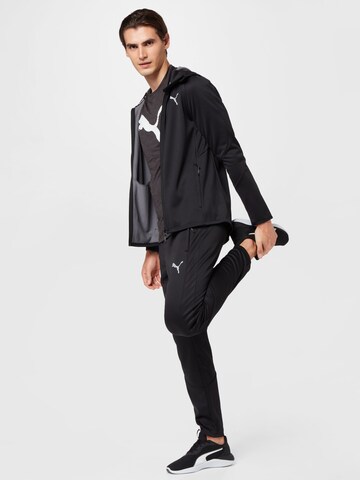 PUMA Sportshirt 'TRAIN FAV' in Schwarz