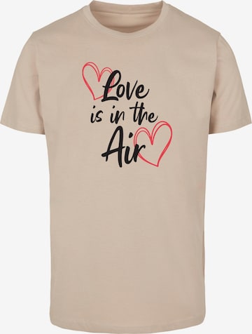 Merchcode T-Shirt 'Valentines Day - Love Is In The Air' in Beige: predná strana