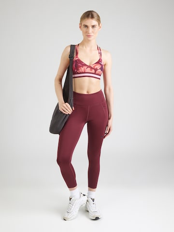 Bustino Reggiseno sportivo di PUMA in rosso