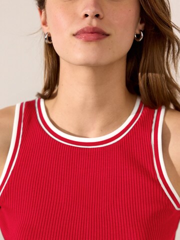 Haut Next en rouge