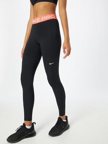 NIKE Skinny Workout Pants in Black: front