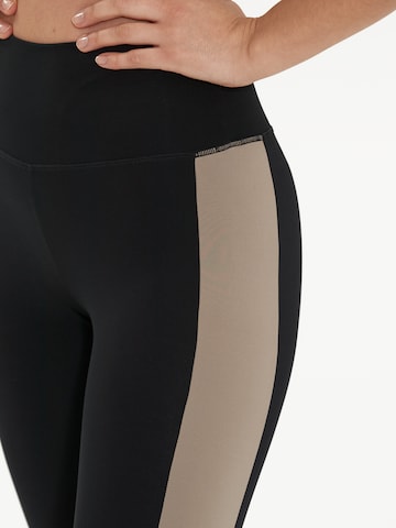 Athlecia Skinny Urheiluhousut 'Comaya' värissä musta