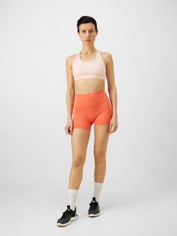 NIKE Bustier Sportmelltartók 'Swoosh' - rózsaszín