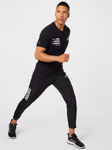 Coupe slim Pantalon de sport 'Own The Run Astro Wind' ADIDAS SPORTSWEAR en noir