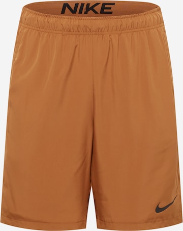 NIKE Sports trousers in Brown: front