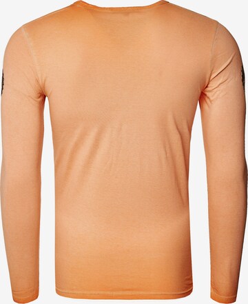 Rusty Neal Langarmshirt mit coolem Front- Print in Orange