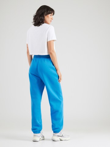 Nike Sportswear Tapered Broek 'Sportswear Phoenix' in Blauw