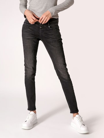 Miracle of Denim Skinny Jeans in Black: front