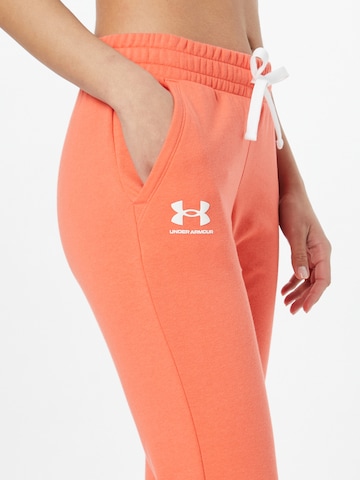 UNDER ARMOUR Tapered Παντελόνι φόρμας 'Rival' σε πορτοκαλί
