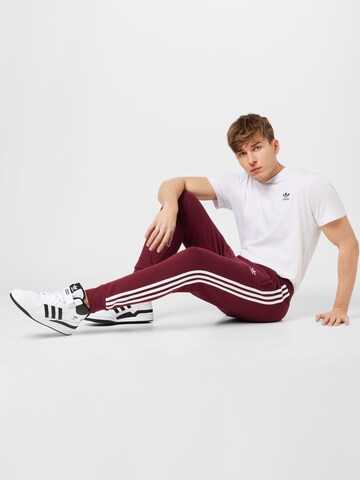 Slimfit Pantaloni 'Adicolor Classics' de la ADIDAS ORIGINALS pe roșu