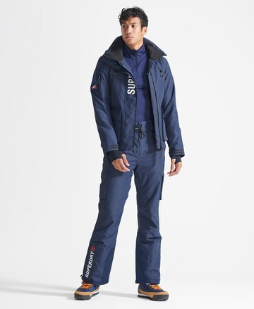 évasé Pantalon de sport 'Ultimate Rescue' Superdry Snow en bleu