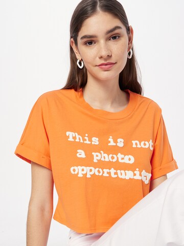 GUESS Tričko 'NOT A PHOTO' – oranžová