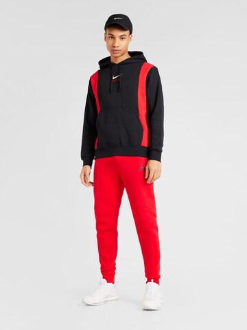 Tapered Pantaloni 'TCH FLEECE' di Nike Sportswear in rosso